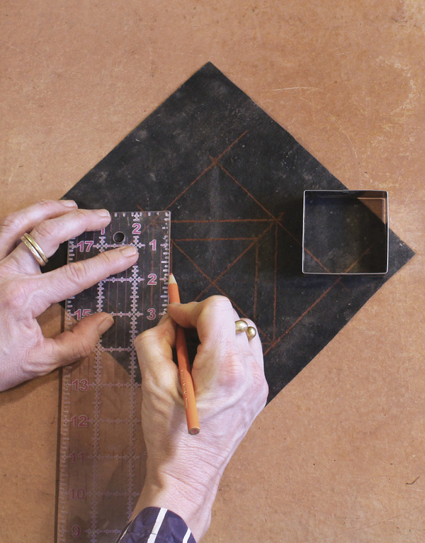 2 Mark center, draw offset 2½-in. (6.4-cm) square/diamond, and cut out center.
