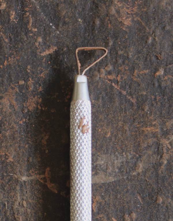 8 Use a right-triangle-shaped, mini ribbon trimming tool for the next step.