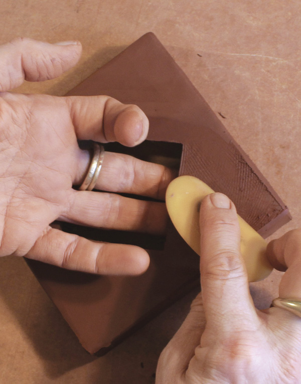 11 While the coil sets up, use serrated rib and rubber rib to smooth the face and edges.