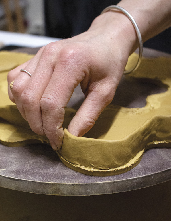 5 Score the thicker edge of the coil, then press it to the top of the slab.