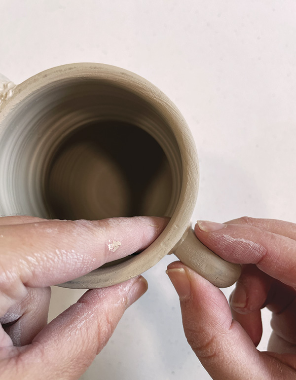 4 Attach two coil handles opposite each other after slipping and scoring.
