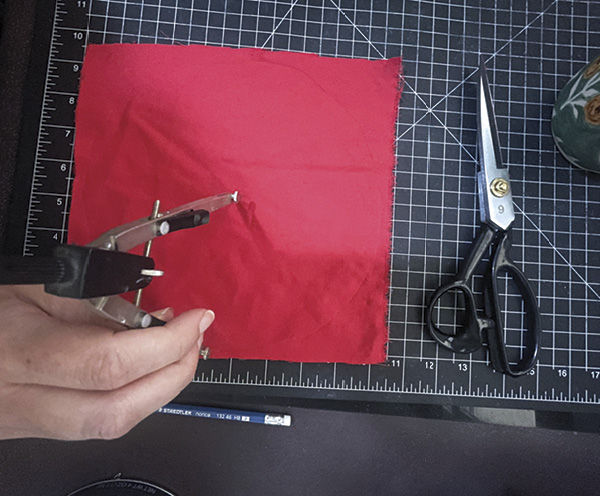 15 Trace and&nbsp;cut a circle of&nbsp;red fabric 2–3× the diameter of your mug opening.