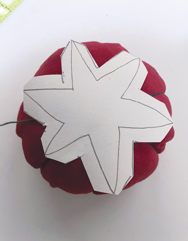 18 Cut a star paper shape for the leaves, then cut it out of green fabric.