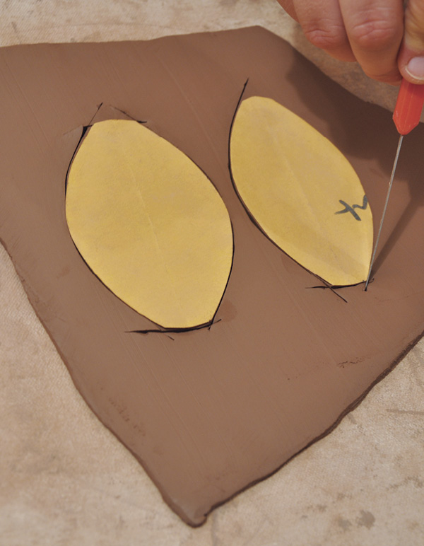 4 Create paper patterns of the handle shape, and cut them out of a clay slab.