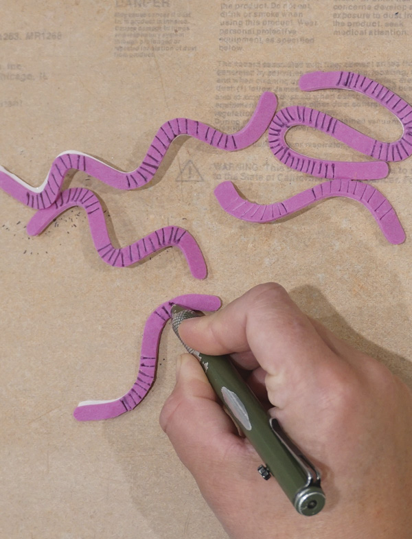2 Cut your shapes, then use a ballpoint pen to impress marks into the foam.
