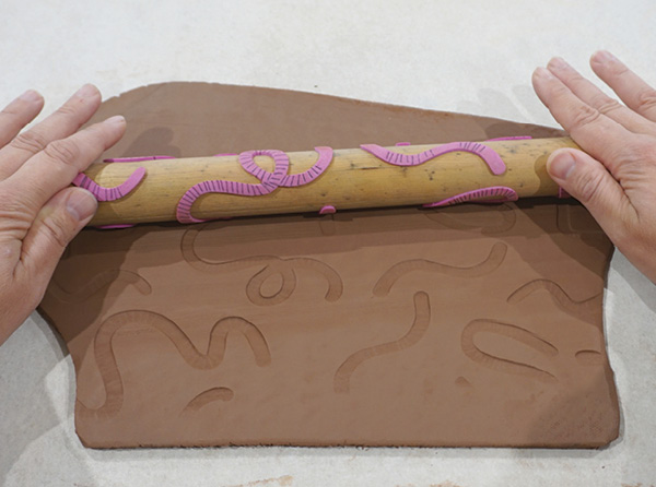 4 Roll the finished texture roller across a freshly rolled slab using even pressure.