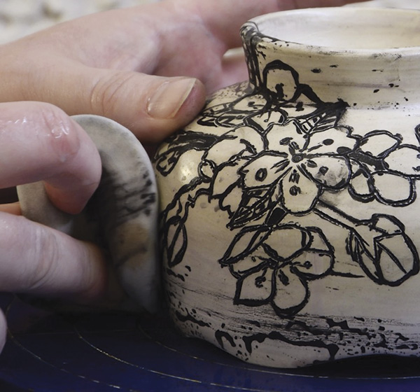 6 Clean off excess underglaze with a dense sponge, rinsing it periodically.