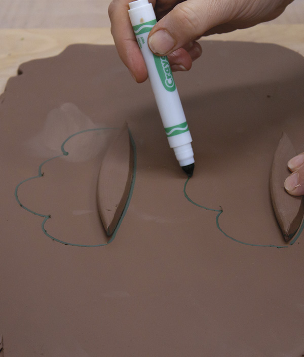 4 Use the cut pieces as a template for the bottom edge of the rim pieces. Draw on the slab with a water-based marker.