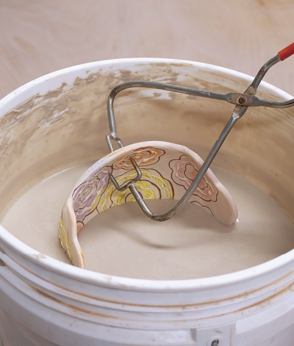 18 Apply clear glaze over the entire bowl by dipping or brushing, then wipe the foot ring before the final firing.