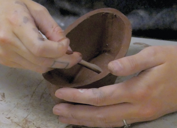 4 Compress the interior seams of the bowl using a rounded wooden knife.