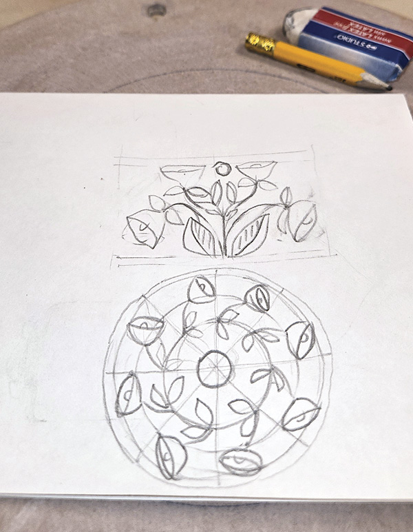 1 Sketch a design on paper that will later be drawn out on the bisque-fired form.