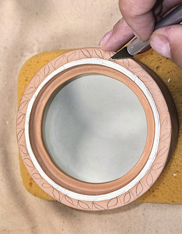 6 Use a knife with a sharp tip to scrape off any glaze mistakes.