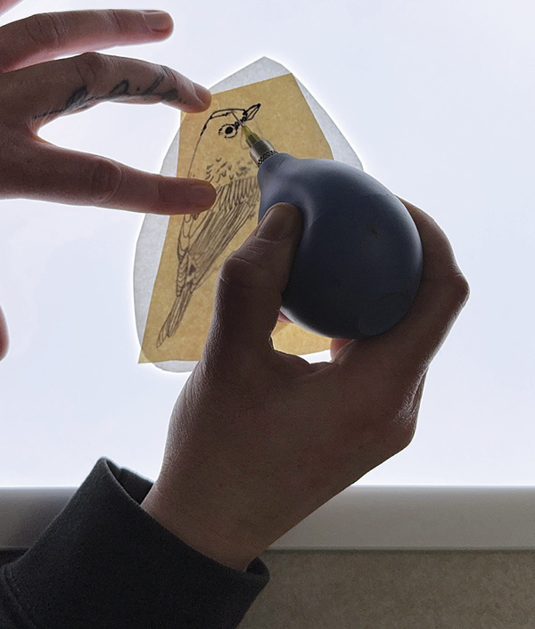 1 Draw out a transfer image on newsprint using black underglaze.