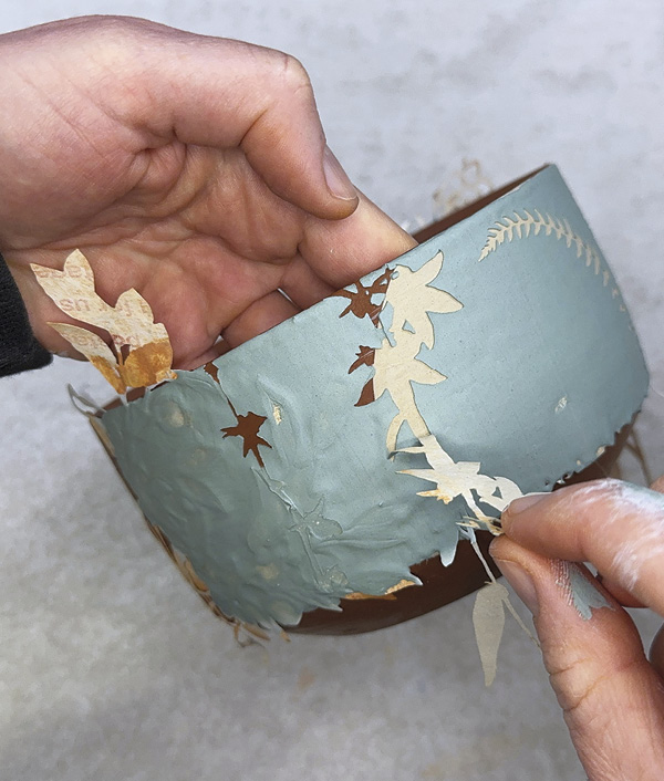 10 Once the slip has dried, peel away all but the etched stencil.