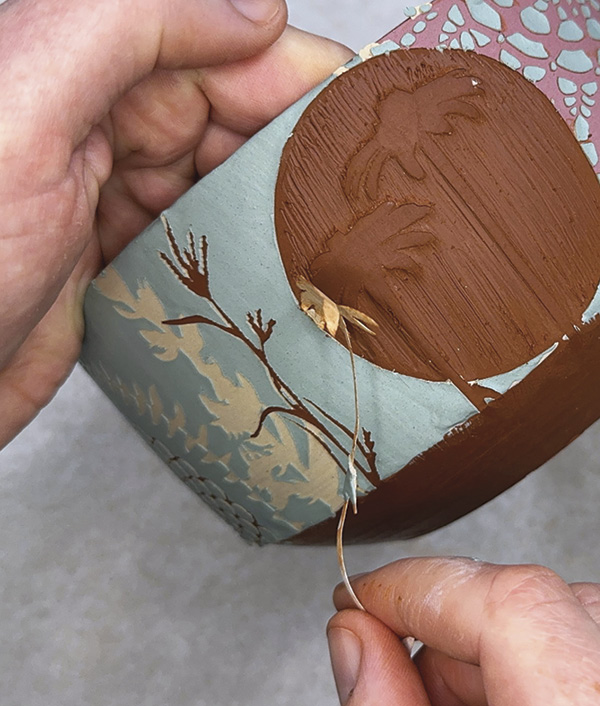 12 Peel off the last stencil to reveal the smooth clay underneath.