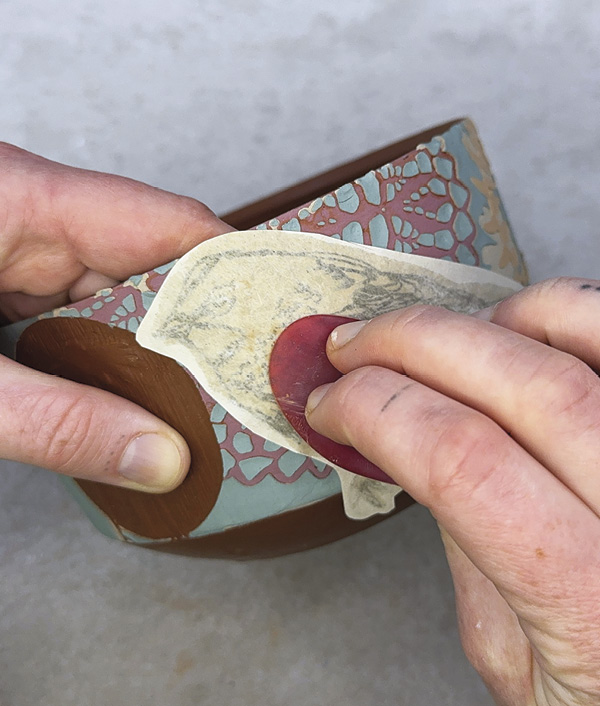 16 Place the transfer and apply pressure with rib and sponge to adhere.