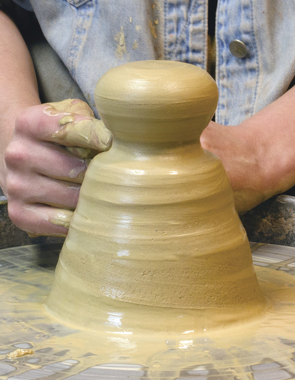 1 Section off a baseball-size lump of clay. Form a doorknob shape with a flat top.