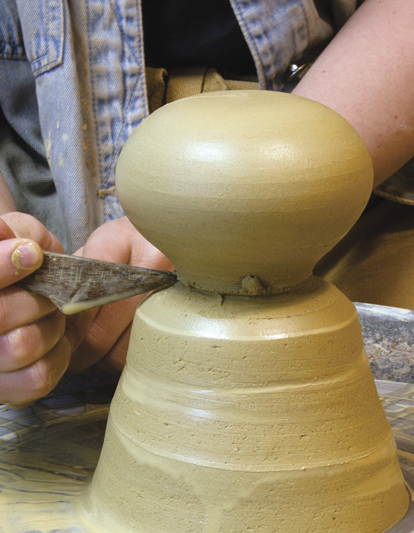 3 Mark the base, then cut it off using a wire while slowly turning the wheel.