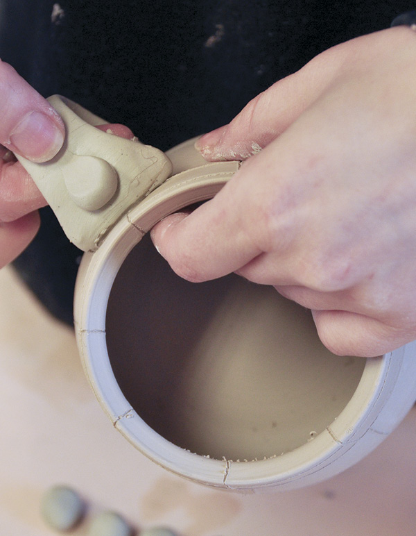 3 Form and attach a colored-clay handle to the mug.