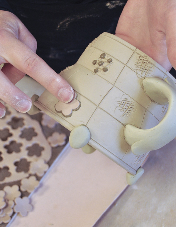 7 Attach a second colored-clay cutout in various places throughout the form.