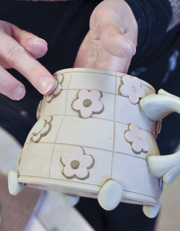 8 Attach the flowers with a contrasting black slip.