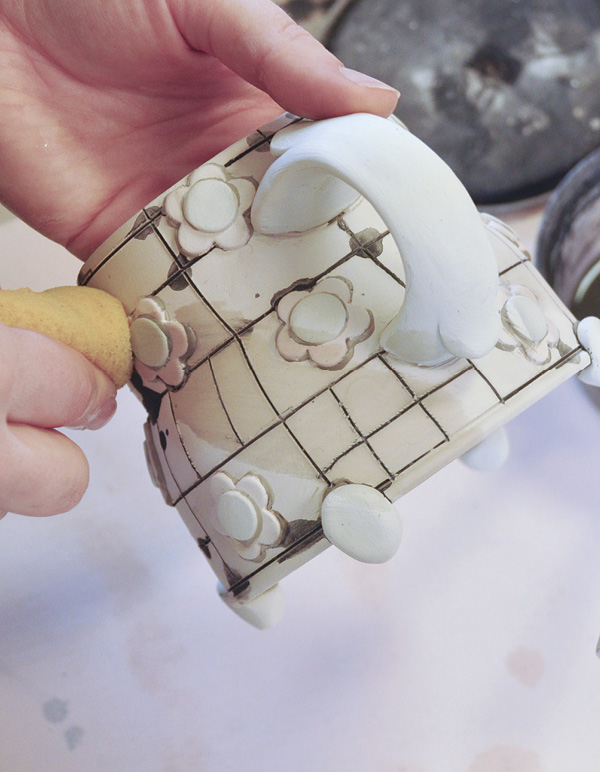 11 Wipe away excess stain with a clean, damp sponge.