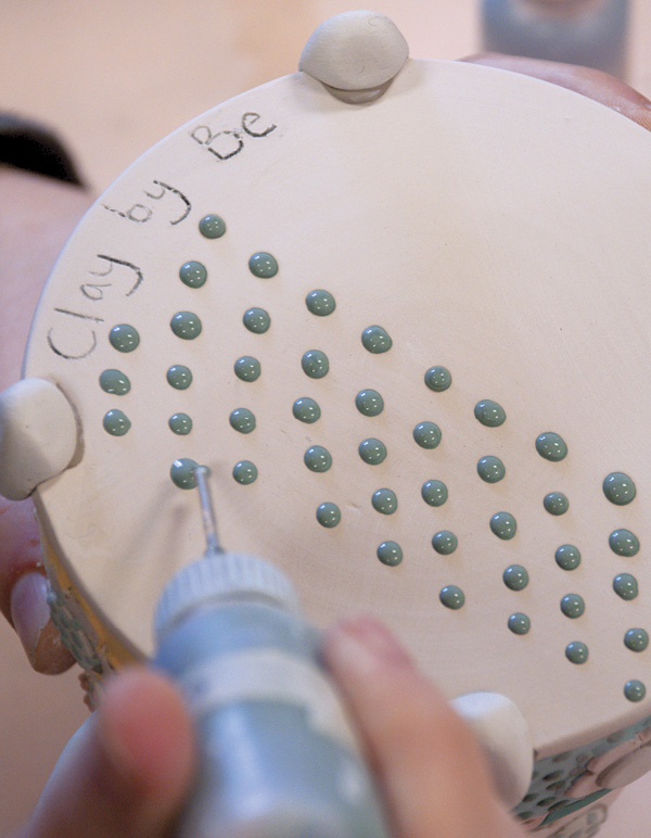 15 Trail colored-slip dots on bottom to fully wrap the design around the form.