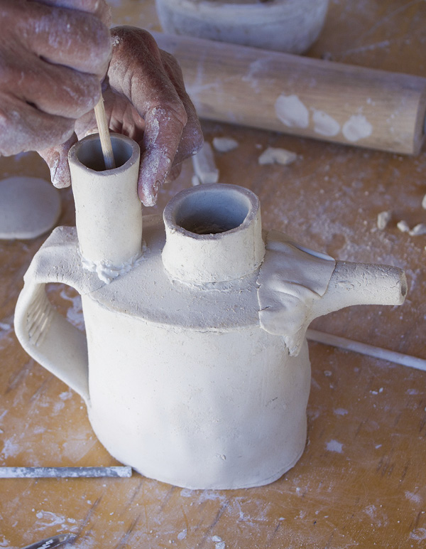 11 Slip, score, and securely attach the tea infuser to the top slab around the holes.