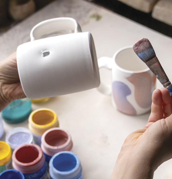 1 Dip the mop brush in a thinned underglaze. Layer a thicker underglaze on top.