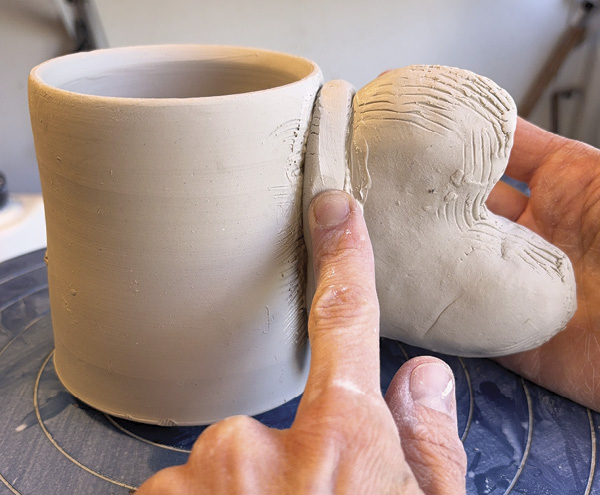 8 Add a coil at the seam and work the form and the shape together with the serrated rib.