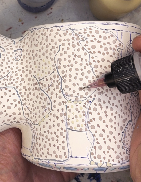 14 Add colorful designs, bisque fire again, apply a liner glaze before a final firing.