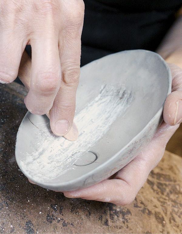 9 Use a wooden modeling tool to create a distressed surface on the white sigillata.