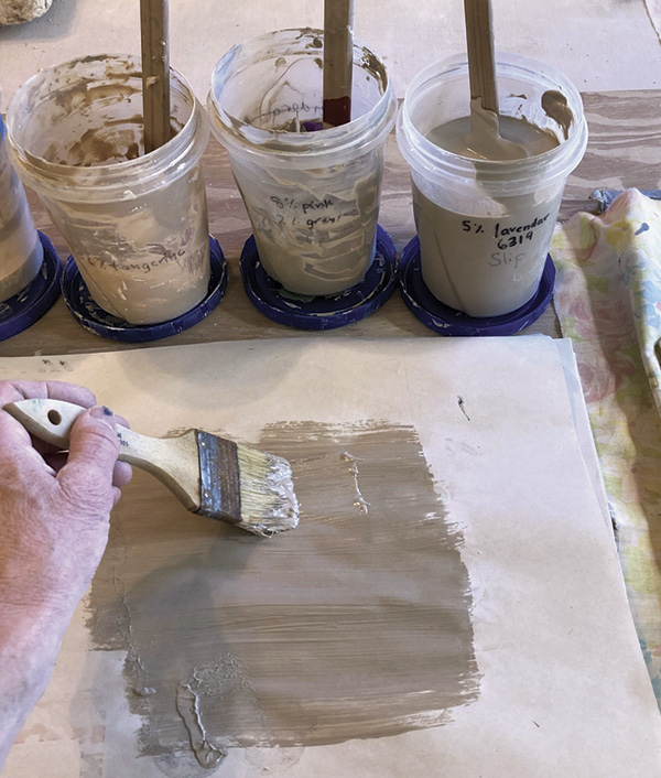 2 Paint a layer of thick colored slip onto newsprint. I use the same sheets of newsprint over and over.