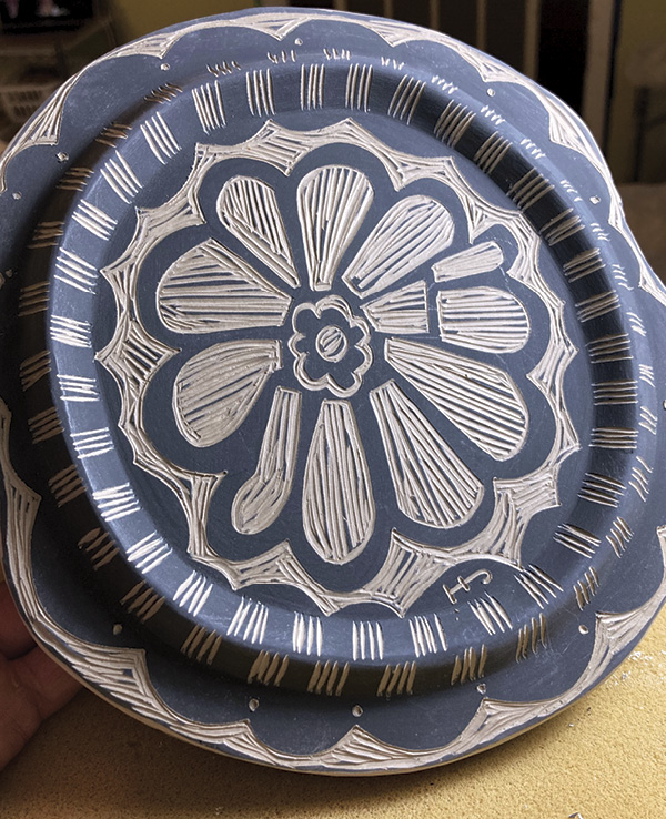 23 Brush underglaze or slip on the bottom. Scratch a floof using sgraffito tools.