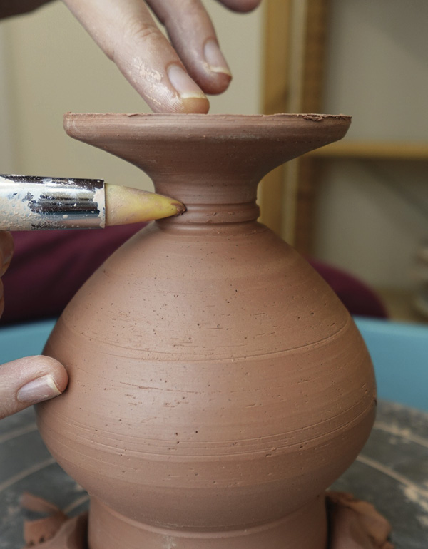5 Use the clay shaper tool to create an indent detail on the pedestal foot.