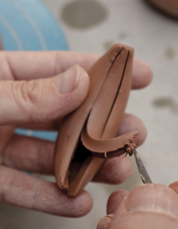 13 Remove a slither of clay from the puffy shape using a craft knife.
