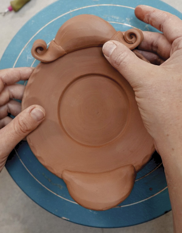 15 Attach curls to cover the join of the puffy handle and saucer.