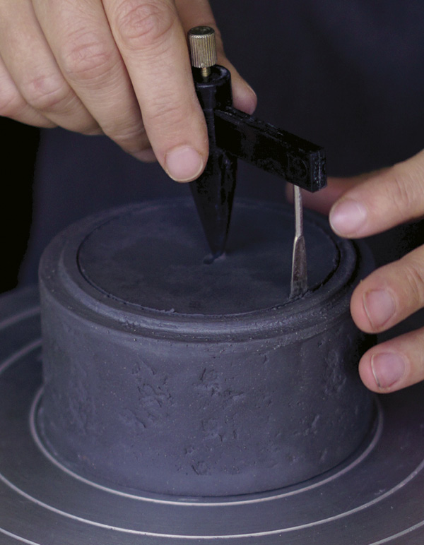 13 Slowly rotate the banding wheel and cut a hole with the circle cutter.