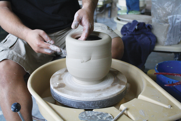 4 Drag a palette knife quickly over the clay while the wheel moves slowly to alter a form.