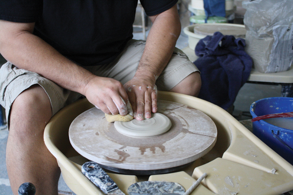 6 Center then throw a small piece of clay into a low, wide disc in preparation for making the lid.