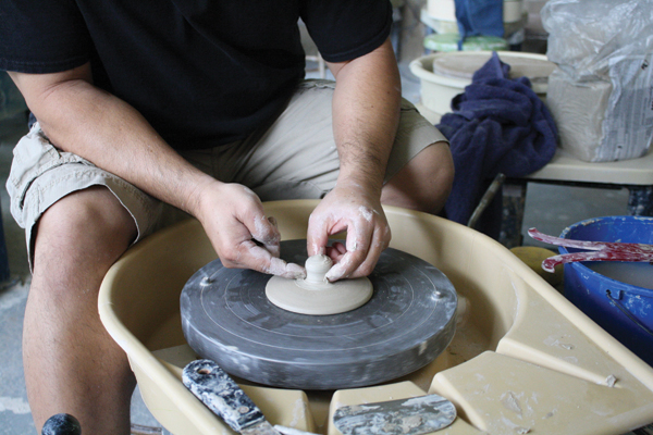 8 Once the lid reaches leather hard, add a small ball of clay, and throw it into a hollow or solid knob.