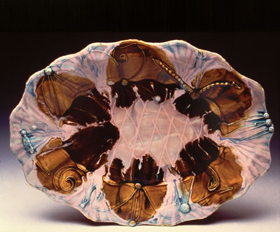 The flowing, drippy surfaces on Kari Radasch's work are achieved by layering glazes with various melting points.