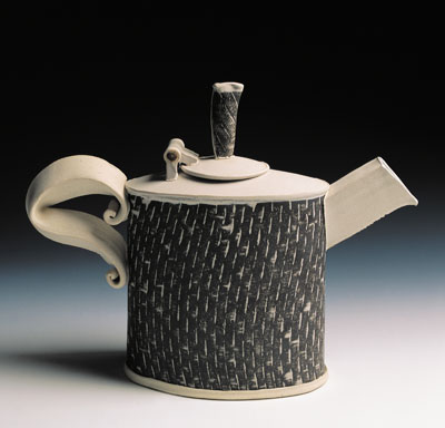 This stoneware teapot shows the subtle twist created in the pattern when the stenciled slab was stretched.