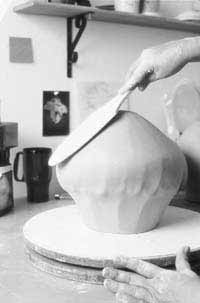 Then, the form is inverted and paddled to compress the clay and refine the contour of the bottom.