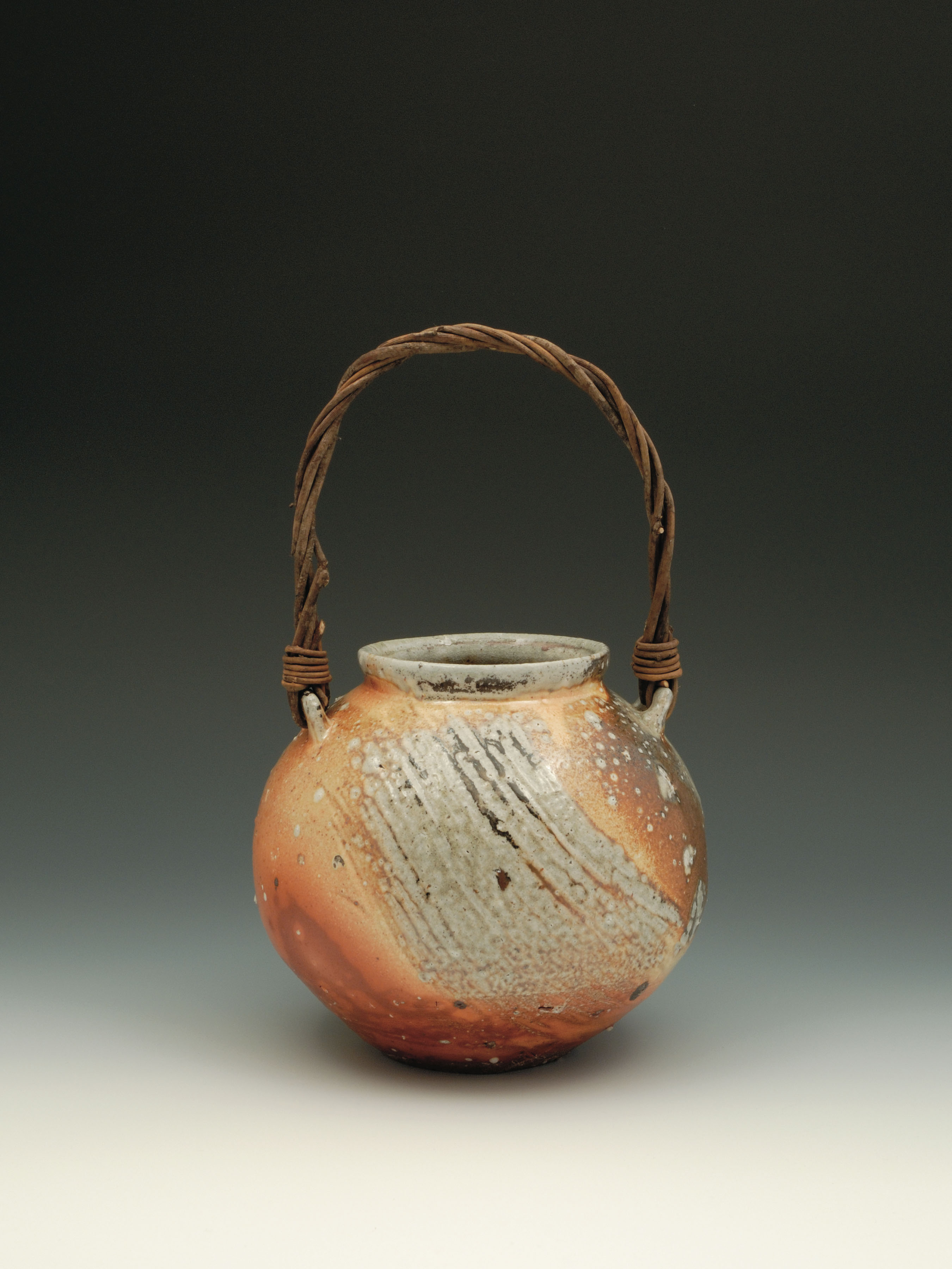 Round jar, 15 in. (38 cm) in height, thrown stoneware with wisteria handle by Lee Dalby, soda glaze, fired to Cone 12.