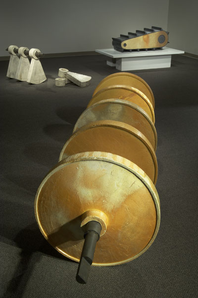 Pieces from the 20th Century Artifact series. Clockwise from upper left: Counter Weight, 28 in. (71 cm) in height; Track, 48 in. (1.2 m) in length; Wheels, 144 in. (3.6 m) in length, each wheel 32 in. (81 cm) in diameter. All pieces are salt-fired stoneware, 2005.