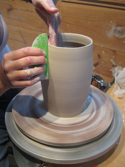 3. Pull the walls of the pitcher’s neck tall, and use a rib to curve the profile.
