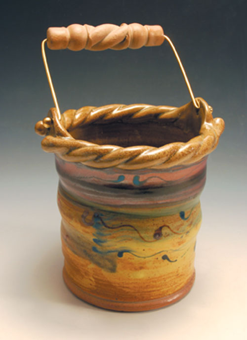 Rope-top bucket, 8 in. (20 cm) in height, with ceramic and brass handle and extruded rim.