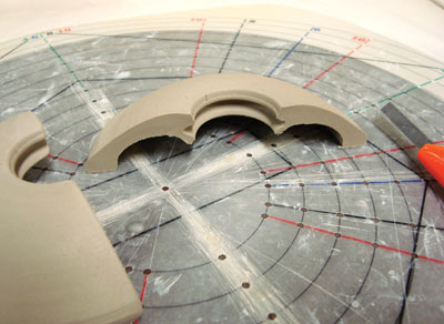 Fig.13 I bisect a prepared lid form. The center opening has a trimmed groove for a knob/disc combination.