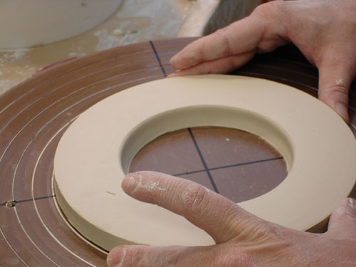 Fig.1 Throw a slab. Allow it to firm up, cut a circle equal to the foot of the cup. Make marks on the wheel to determine where to cut the outside edges of the footwell.